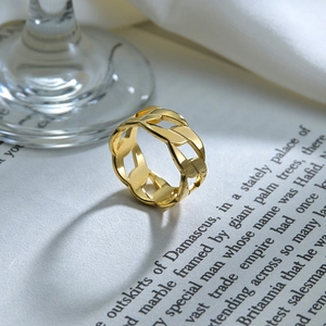 Detailed view of 9mm gold punk chain link ring displayed on an open vintage book