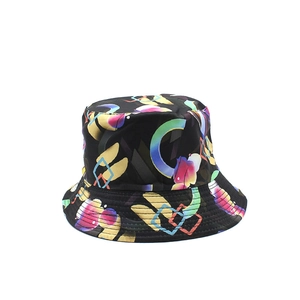 Artistic reversible bucket hat with colorful abstract geometric prints on black fabric