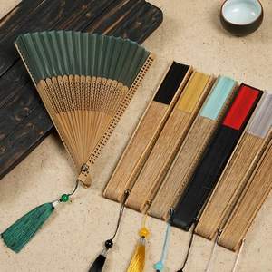 Traditional Chinese silk folding fan with bamboo frame and tassels in various colors
