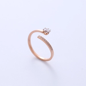 Minimalist rose gold zircon ring with single diamond and row accents in an open design