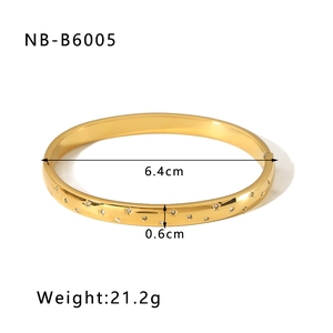 Detail view of gold star-engraved stainless steel bangle with dimensions and weight specs