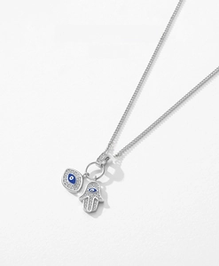 Detailed macro of S925 silver Hamsa hand necklace with blue evil eye and zircon inlay