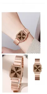 Detail of rose gold square watch with dark brown sunburst dial and metal link bracelet