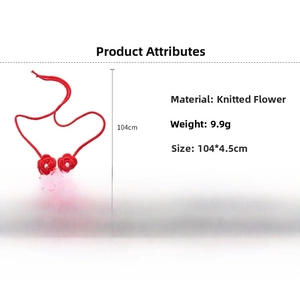Detail of red knitted flower necklace with white faux pearl core and woven rope