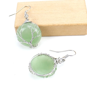 Detailed wire-wrapped tree of life design on green crystal gemstone earring
