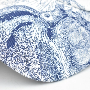 Detailed close-up of blue and white Toile de Jouy print on a twill canvas baseball cap