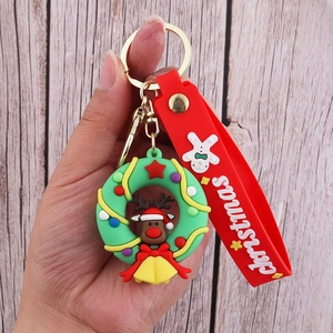 Detail showing Christmas keychain with green wreath, reindeer doll, and red wrist strap