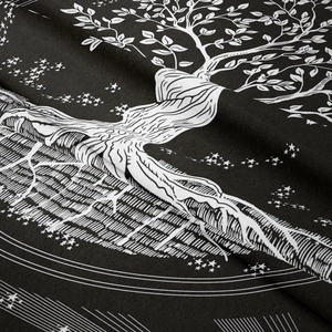 Detailed close-up showing the fabric texture and white tree of life print on black tapestry