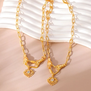 Gold evil eye necklaces with hand charms and zircon pendants in bohemian style