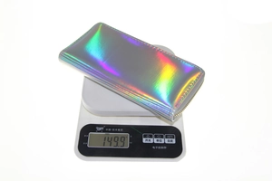 Detailed view of iridescent laser PU leather long wallet on scale weighing 149.9 grams