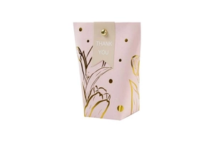Detailed view of pink gift bag with gold foil flower patterns and Thank You label
