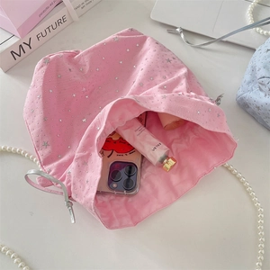 Pink drawstring canvas bucket bag with silver stars and interior storage capacity