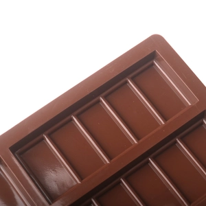 Detailed close-up of brown silicone chocolate mold with rectangular cavity patterns