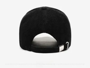 Close-up of black textured wool baseball cap featuring adjustable silver metal buckle