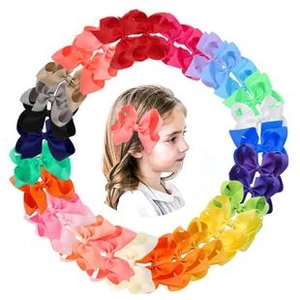 Close-up of colorful ribbon bow hair clips arranged in a circle for children