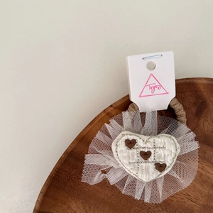 Sweet cream heart knitted hair tie with white lace mesh ruffle on wooden tray