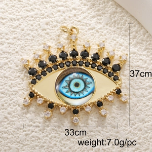 Detailed view of evil eye jewelry pendant with gold finish and zircon stones