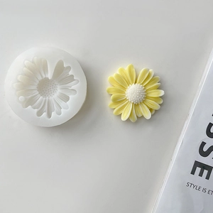 Detail of white silicone sunflower mold with a finished yellow daisy resin craft