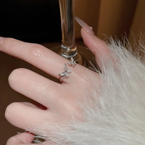 Close-up of elegant zircon butterfly open ring worn on finger for a luxury look