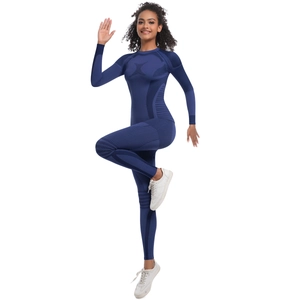 Detail of navy blue seamless knit jumpsuit showing breathable ribbed texture and side panels