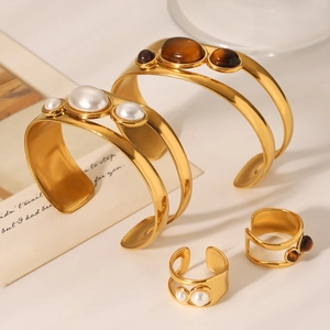 Polished gold stainless steel bangles set with natural tiger eye stone and white pearls