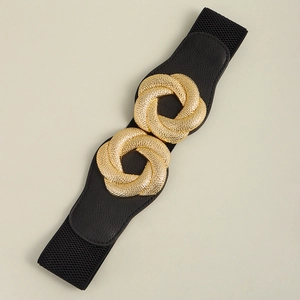 Detail of black elastic belt with textured gold interlocking round buckles for women