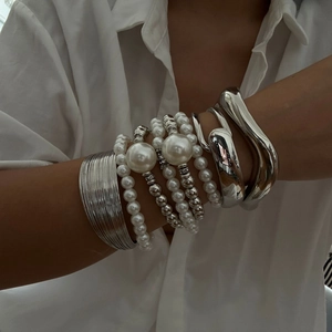 Layered silver-tone bangle set featuring beaded pearls and minimalist open cuff design