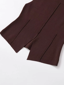 Close-up of split hem and decorative seam on a dark coffee knitted top for women