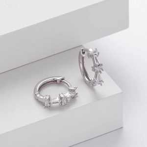 Detailed macro view of S925 silver hoop earrings with rectangular cubic zirconia stones
