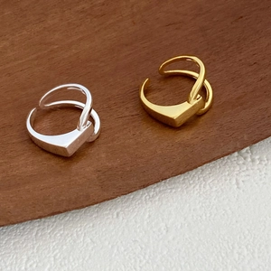 Detail view of gold and silver S925 sterling silver rings with geometric lines
