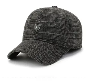 Detail view of winter plaid baseball cap with thick textured fabric and shield logo