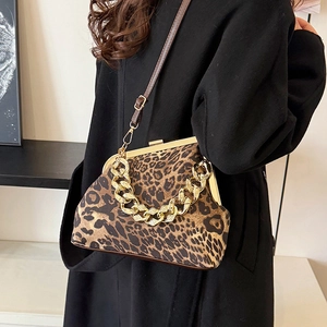 Women's leopard print shell bag with gold chain strap and adjustable leather crossbody strap