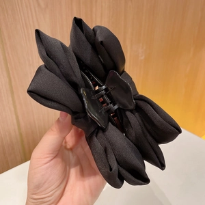 Close-up of the black fabric double-sided bow hair claw clip for girls and women