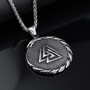 Macro view of oxidized Viking Valknut pendant with thick stainless steel wheat chain