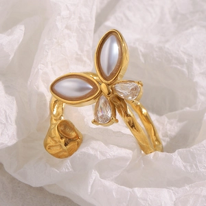 Macro detail of 18K gold plated butterfly open ring with resin pearls and zircons