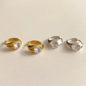 Detailed view of silver and gold 925 hoop earrings set with clear zircon crystals