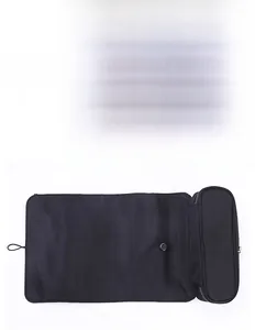 Detailed view of black folding makeup brush bag featuring a premium silver metal zipper