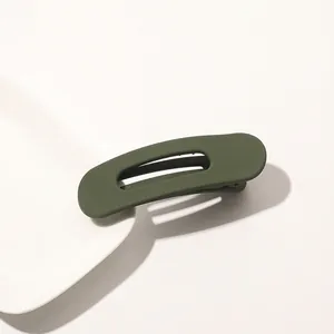 Macro view of olive green matte hair clip with hollow design on white background