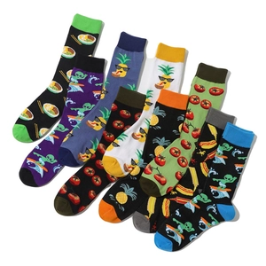 Detail view of cotton socks with creative prints like aliens, pineapples, and tomatoes