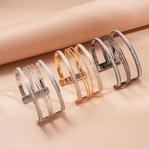 Multi-layered geometric metallic open bangles in gold, silver, and black finish