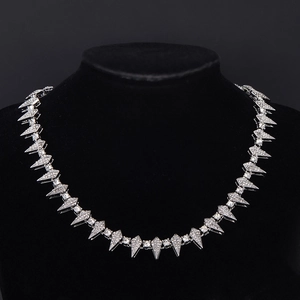 Silver hip hop Cuban chain with sparkling rhinestones on a black display stand