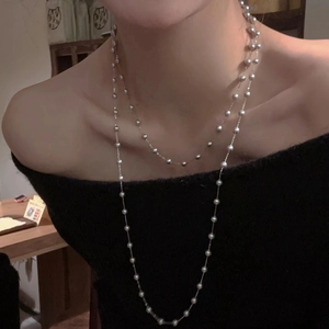 Double-layered artificial pearl necklace with minimalist gold chains for elegant layering