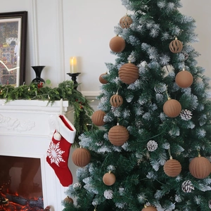Brown velvet Christmas ball set with various textures on a snowy holiday tree decoration