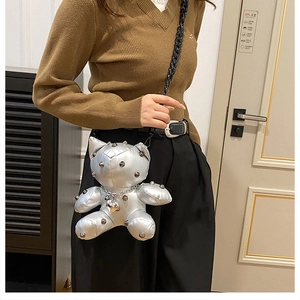 Silver teddy bear doll crossbody bag with metallic rivets and black chain strap detail