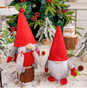 Detail of Christmas gnomes with berries on faux snow with festive pine cones background