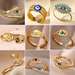 Collection of gold adjustable evil eye rings with colorful enamel and zircon stones