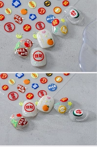 Close-up of 5D embossed nail art stickers with lucky characters and festive patterns