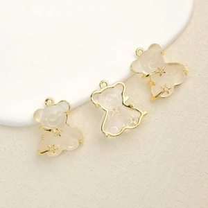 Three cute resin bear pendants with gold trim and stars on a clean background
