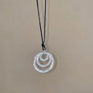 Three-ring crystal pendant necklace with sparkling diamonds and black leather cord