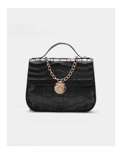 Close-up of black croc-embossed handbag with gold twist lock and elegant metal chain strap